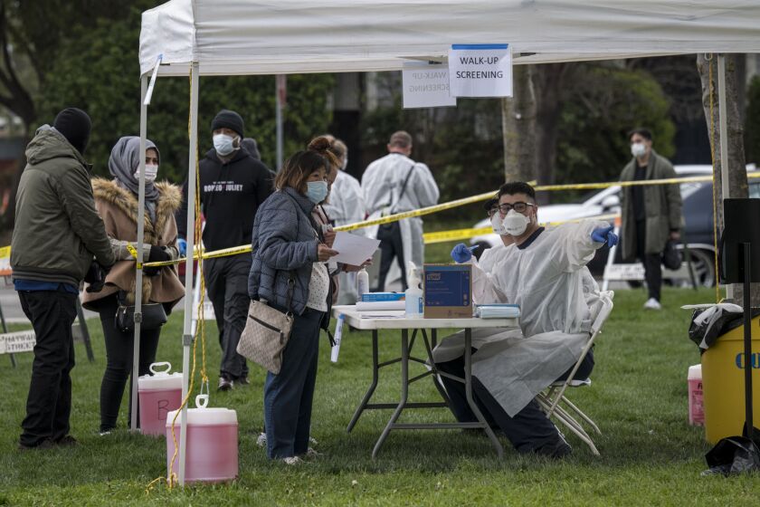 A medical personal directs a patient at a free Covid-19 testing site in Hayward, California, U.S., on Monday, March 23, 2020. Governor Newsom on March 19 ordered that all of the states 40 million residents go into home isolation while saying outdoor activity is permissible with proper social distancing. Photographer: David Paul Morris/Bloomberg