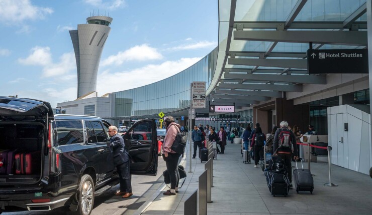 Travelers outside San Francisco International Airport