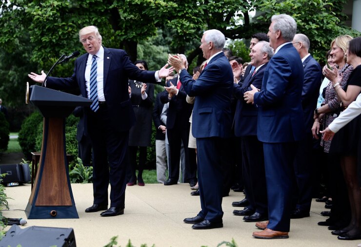 President Donald Trump, left, speaks as U.S. Vice President Mike Pence, center, applauds during a press conference in the Rose Garden of the White House