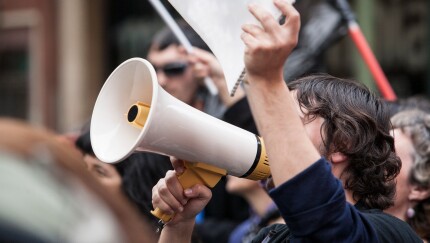 demostrator with megaphone and notebook protesting