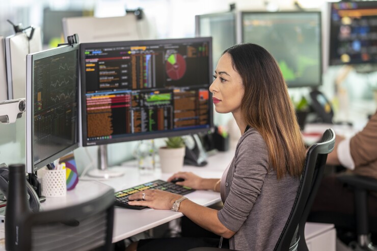 Woman using a Bloomberg terminal