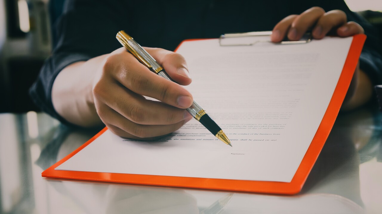 Man holding out a contract.