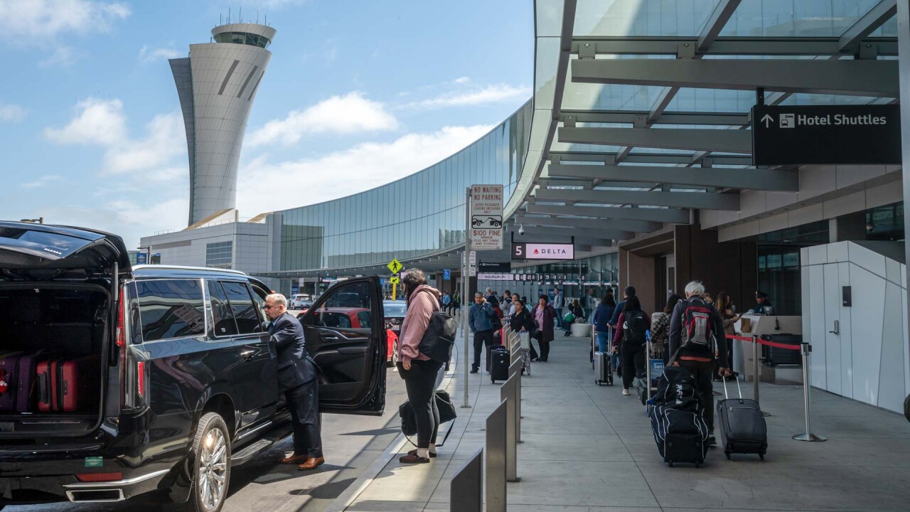 Travelers outside San Francisco International Airport