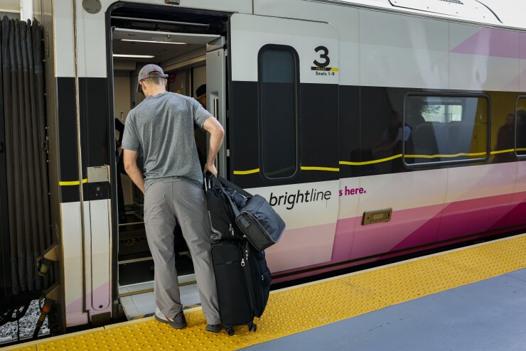 Passenger entering Brightline train in Fort Lauderdale 2024.