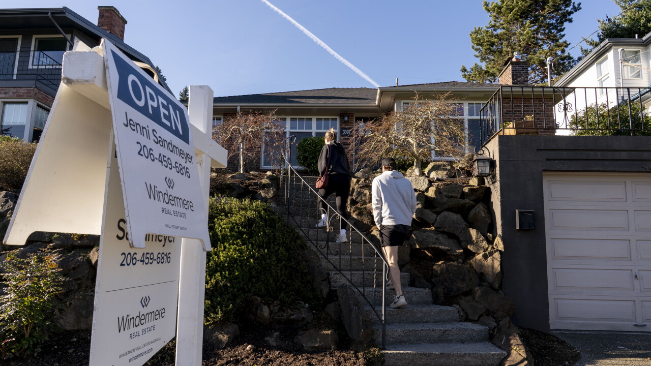 A picture of prospective buyers at an open house at a home in Seattle.