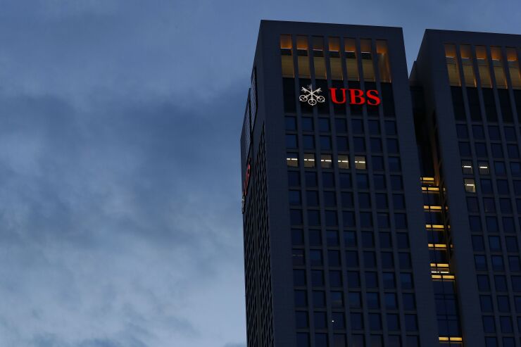 A few office windows sit illuminated at the UBS Group AG offices in the financial district in Frankfurt, Germany, April 29, 2020