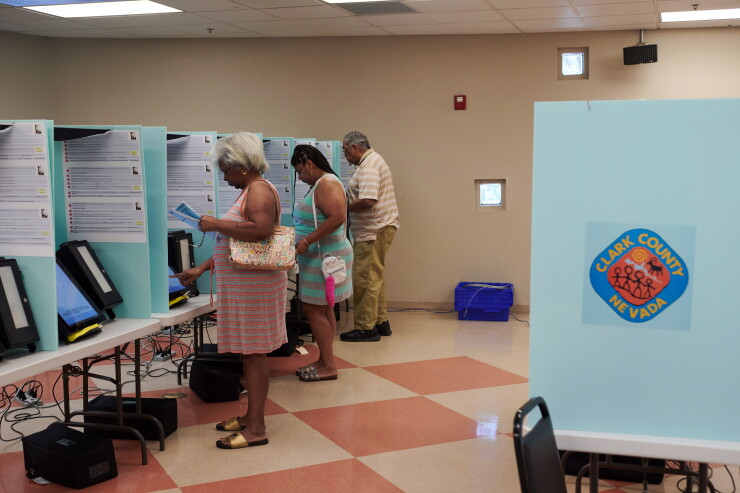 Voters cast their ballots at a polling location during the primary election in Las Vegas, Nevada, U.S., on Tuesday, June 12, 2018.