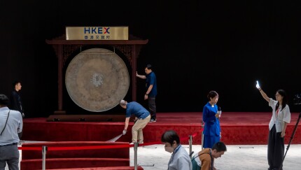 Workers move a gong ahead of a listing ceremony at the Hong Kong Stock Exchange.