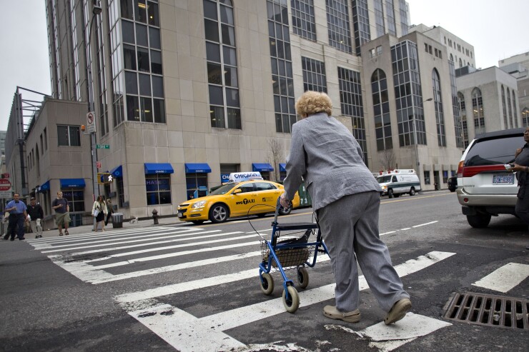 A woman crosses the street outside New York-Presbyterian / Weill Cornell Medical Center in New York City on Thursday, June 11, 2009.