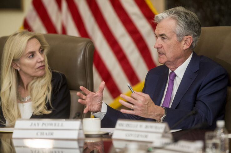 Jerome Powell, chairman of the Federal Reserve, speaks while Gov. Lael Brainard, left, listens.