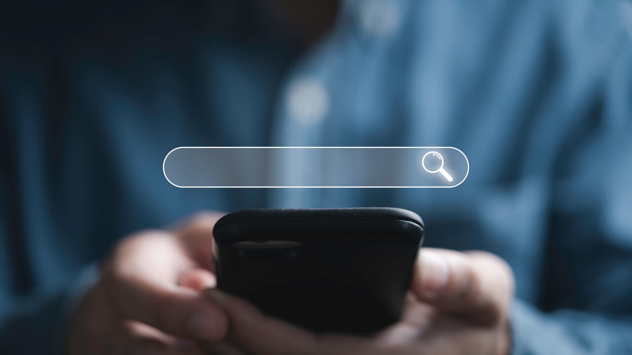 Businessman using smartphone with searching bar icon for Search Engine Optimization or SEO concept to find information by internet connection.