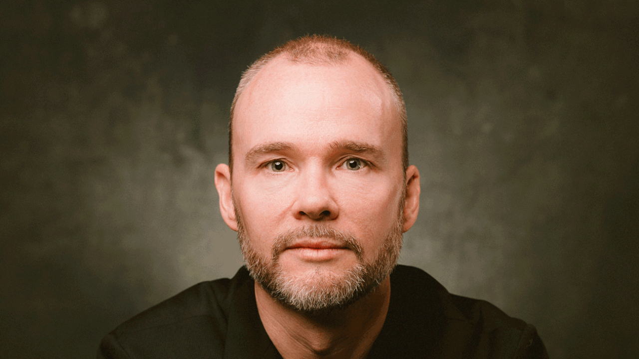 Drew Boyer, founder of Boyer Financial Group, sitting in a black suit