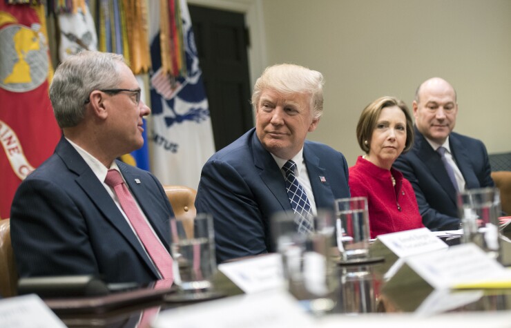 Kenneth Burgess, chairman of the First Capital Bank of Texas, from left, speaks while President Trump, Dorothy Savarese, CEO of the Cape Cod Five Cents Savings Bank, and Gary Cohn, director of the U.S. National Economic Council, listen.