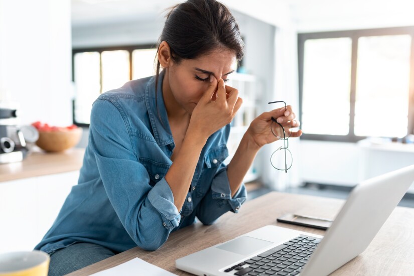 A woman is frustrated at her desk.