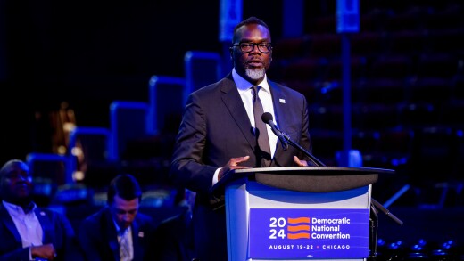 Mayor Brandon Johnson stands at podium