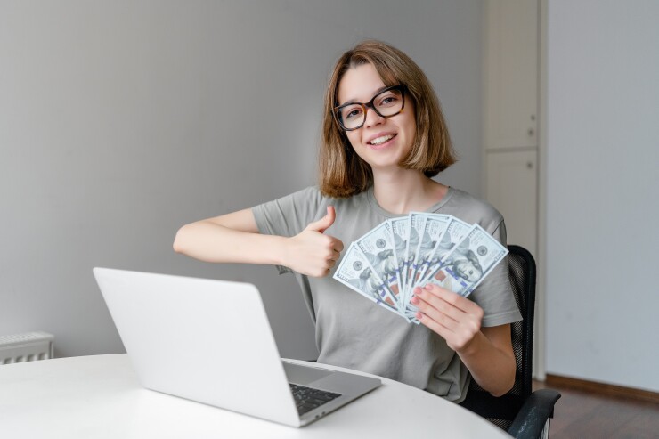 Girl investing in money on computer online