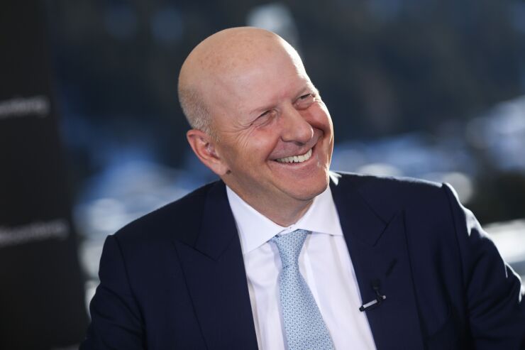 The move by Goldman Sachs CEO David Solomon joins a growing chorus in the industry that's counting on an expanding vaccination drive to hasten the revival of pre-pandemic routines.
