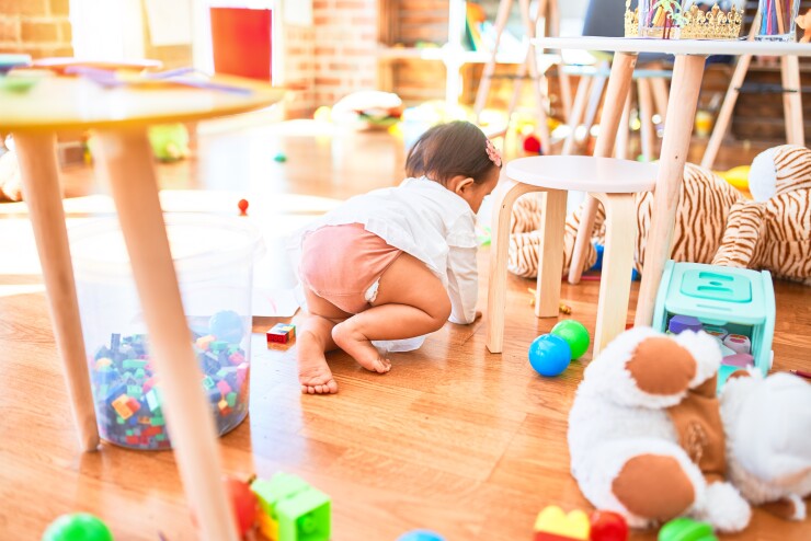 A baby crawling around a daycare center