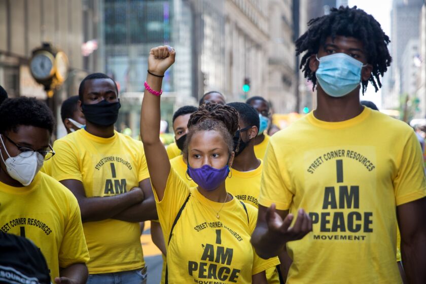 Volunteers from Street Corner Resources stand while protesters, not pictured, shout slogans during the painting of a 'Black Lives Matter' mural along Fifth Avenue in front of Trump Tower in New York, U.S., on Thursday, July 9, 2020. President Donald Trump criticized New York Mayor Bill de Blasio's plan to paint a Black Lives Matter mural on the street outside Trump Tower, saying the effort will antagonize police and will be "denigrating this luxury Avenue."