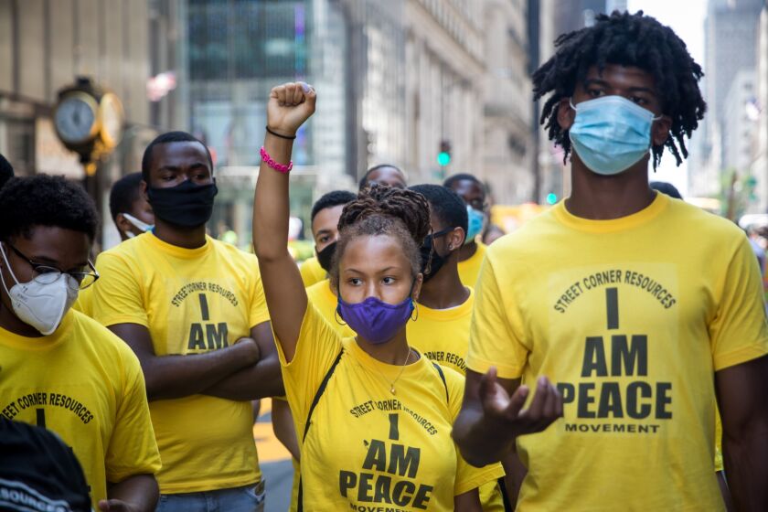 Volunteers from Street Corner Resources stand while protesters, not pictured, shout slogans during the painting of a 'Black Lives Matter' mural along Fifth Avenue in front of Trump Tower in New York, U.S., on Thursday, July 9, 2020. President Donald Trump criticized New York Mayor Bill de Blasio's plan to paint a Black Lives Matter mural on the street outside Trump Tower, saying the effort will antagonize police and will be "denigrating this luxury Avenue." 