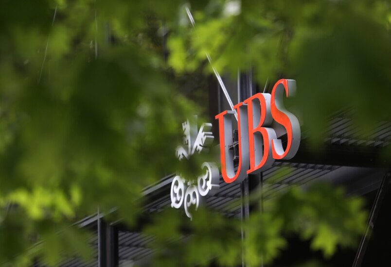 A sign hangs above an entrance to UBS' Broadgate offices in London.