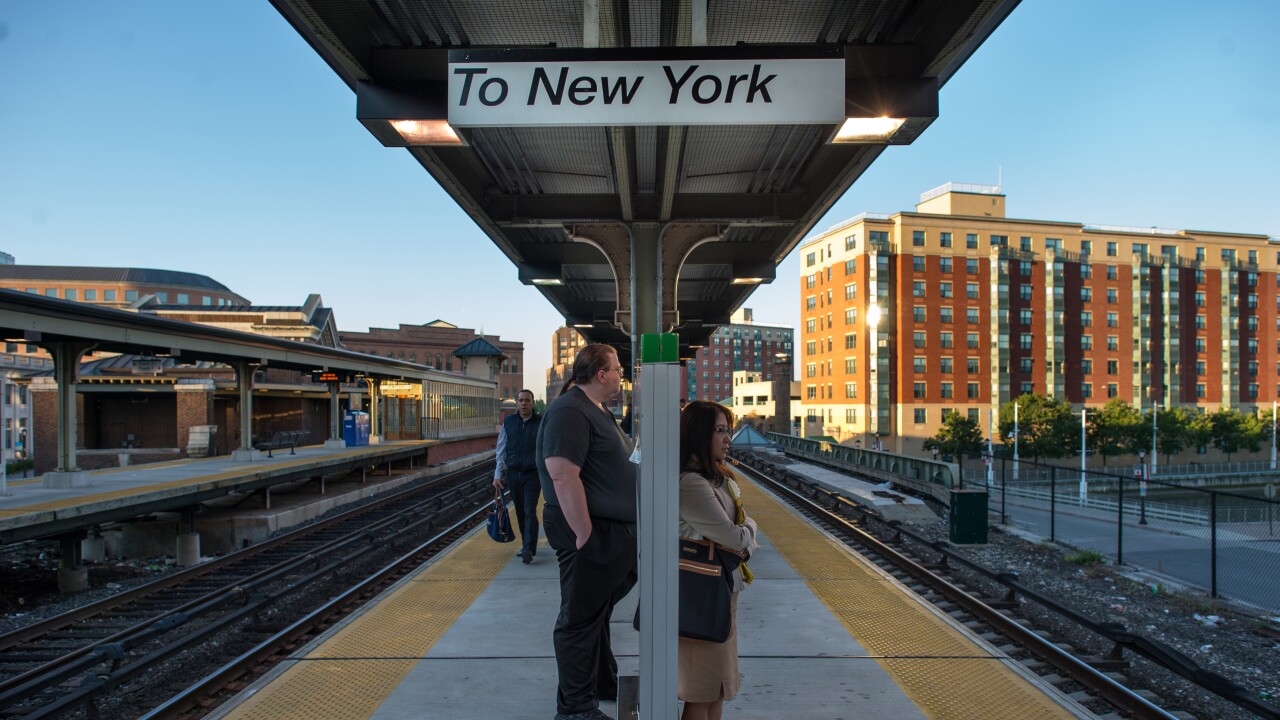 Commuters wait to board a Metro-North Railroad train at the Yonkers Terminal in Yonkers, New York, U.S., on Thursday, Sept. 19, 2013.