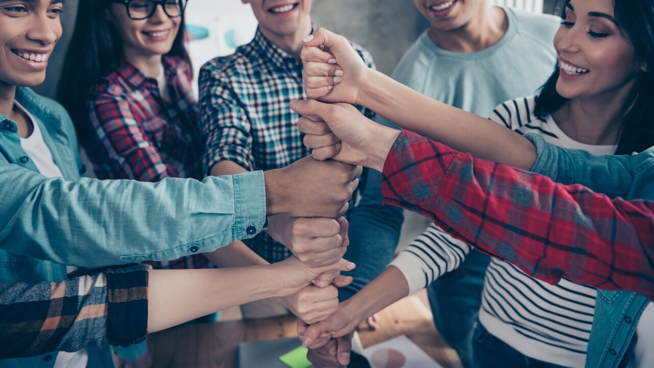 Employees working together, team, fists on top of each other, comradery
