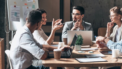 Group of employees sitting at conference table