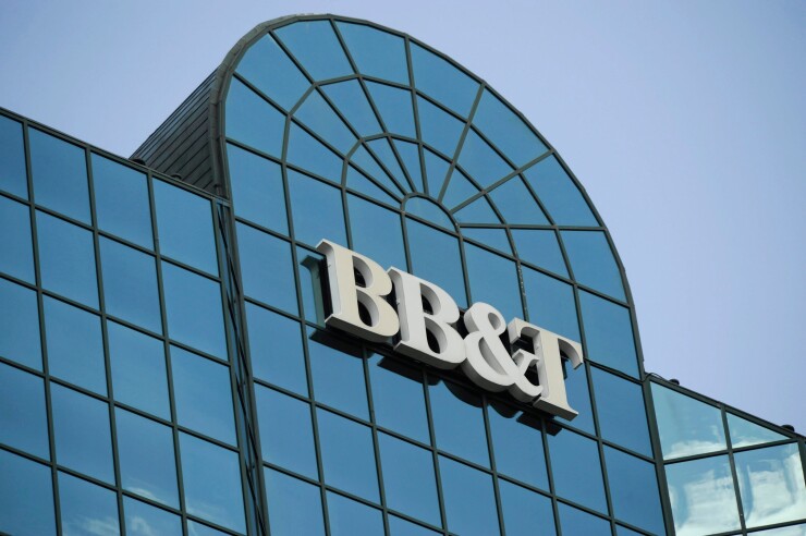 A BB&T logo hangs atop the the bank's headquarters building in Winston-Salem, North Carolina.