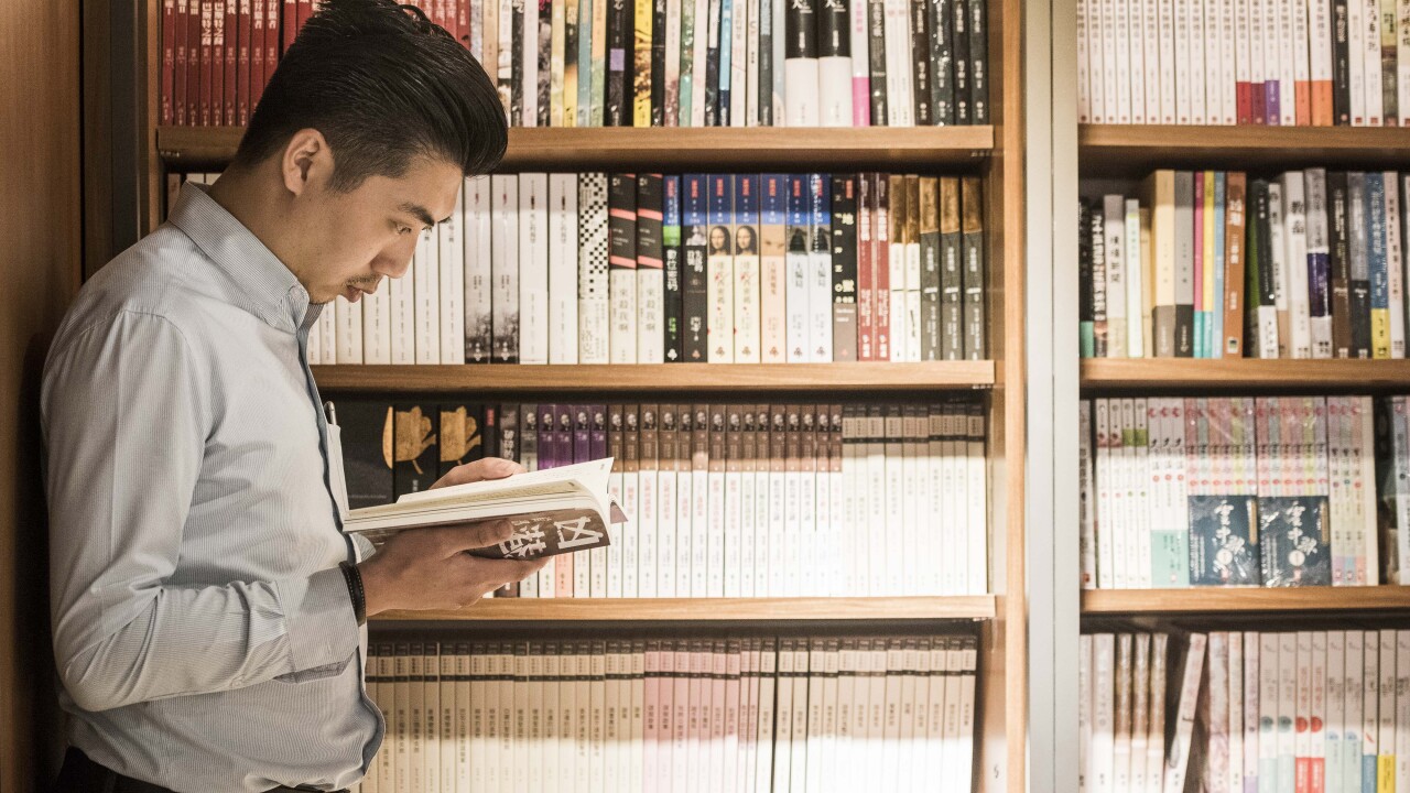 Books asian man reading by Bloomberg News