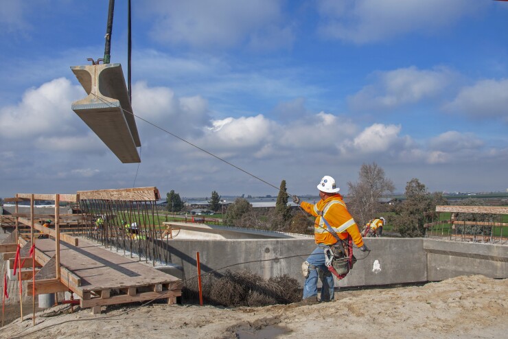 On Jan. 22, 2019, construction workers set girders for a California High-Speed Rail Authority overcrossing in Kings County, south of Hanford.