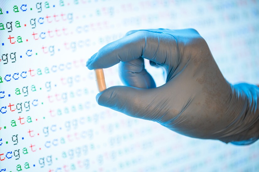 scientist with glove holding one capsule medicine