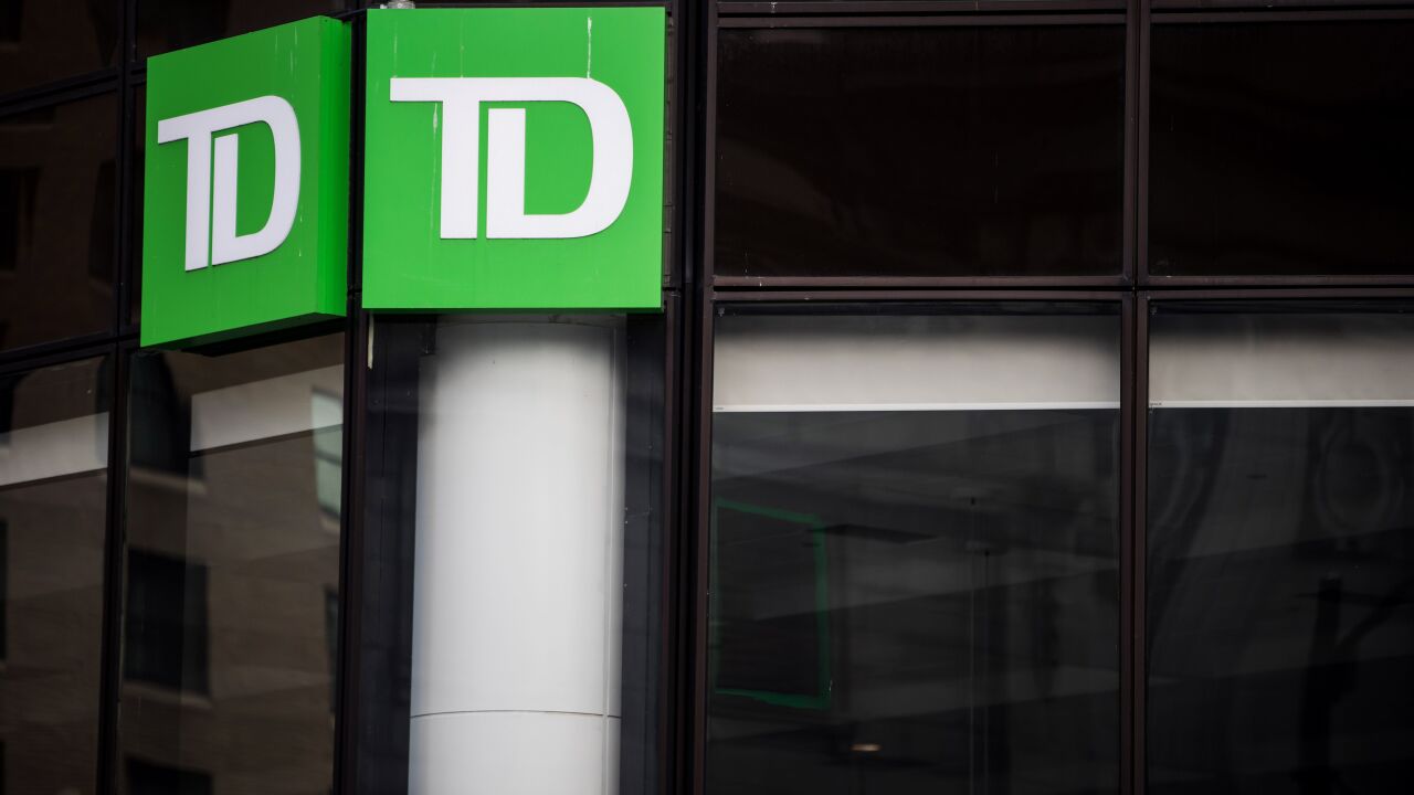 Signage is displayed outside a Toronto-Dominion bank branch in Vancouver.