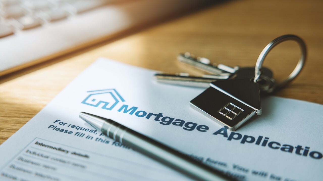 mortgage loan application document and new house keys on the bank office table