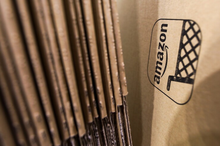 An Amazon.com logo sits on cardboard packaging.