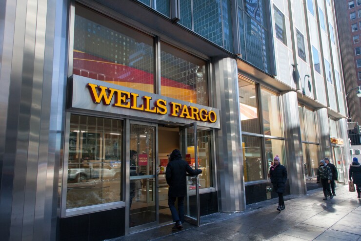 A customer enters a Wells Fargo bank branch in New York.