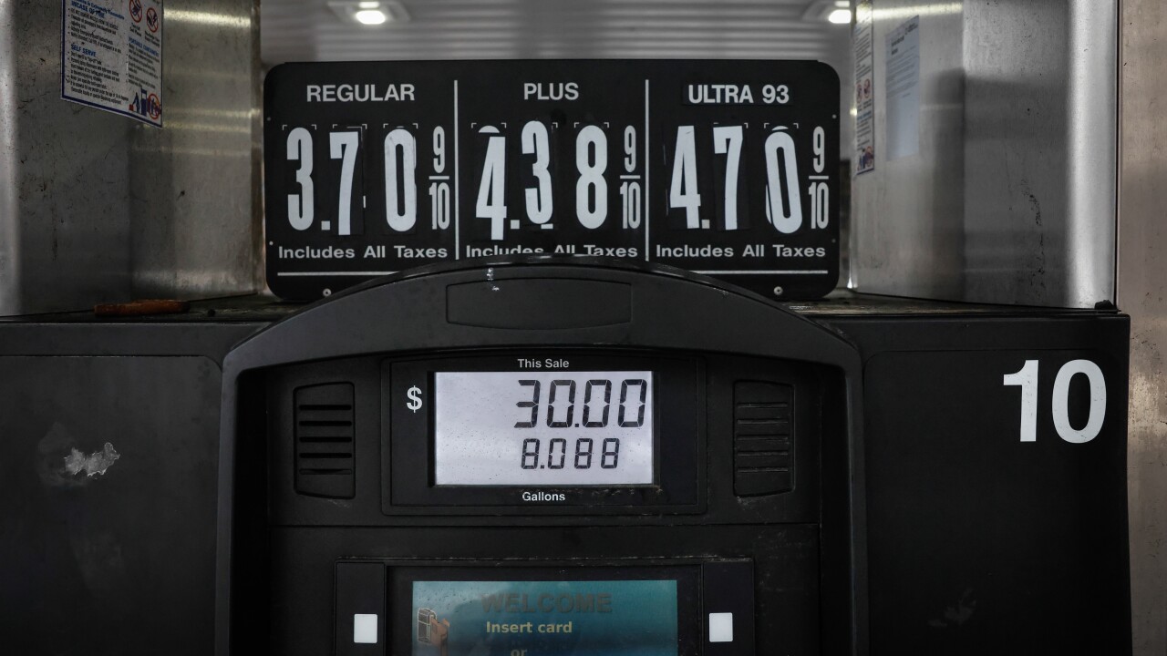 A picture of a gas station pump, with the prices displayed above it.
