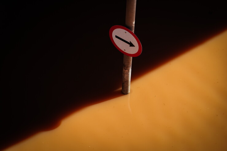 A road sign submerged in floodwater. Photographer: Carlos Macedo/Bloomberg