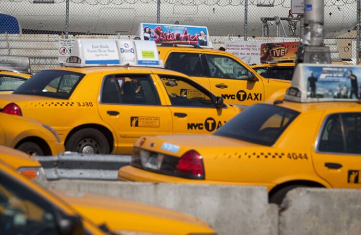 Taxi cabs wait to pick up passengers at LaGuardia Airport in New York.