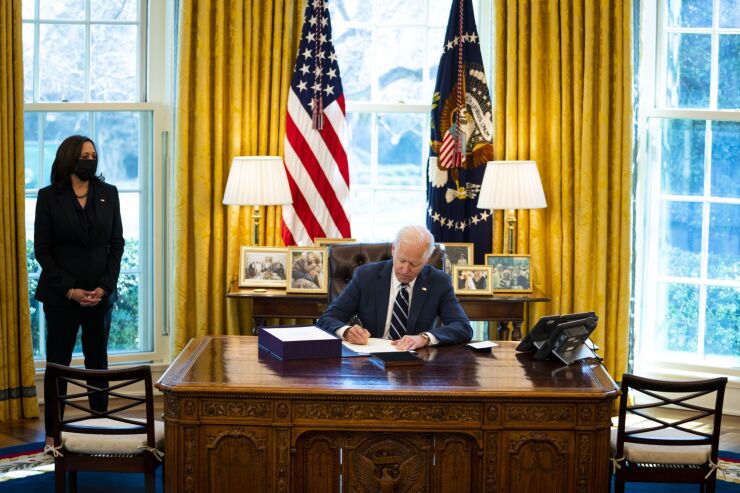 President Biden signing the $1.9 trillion COVID relief package on March 11, 2021. While aimed at ordinary Americans, some wealthy clients can benefit from its generous provisions.