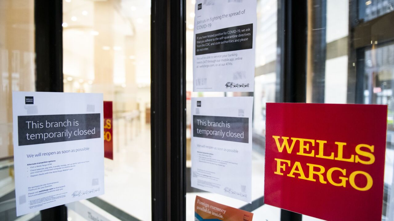 Temporarily closed sign is displayed in the window of a Wells Fargo branch in an effort to stem the spread of COVID-19 in New York April 2020