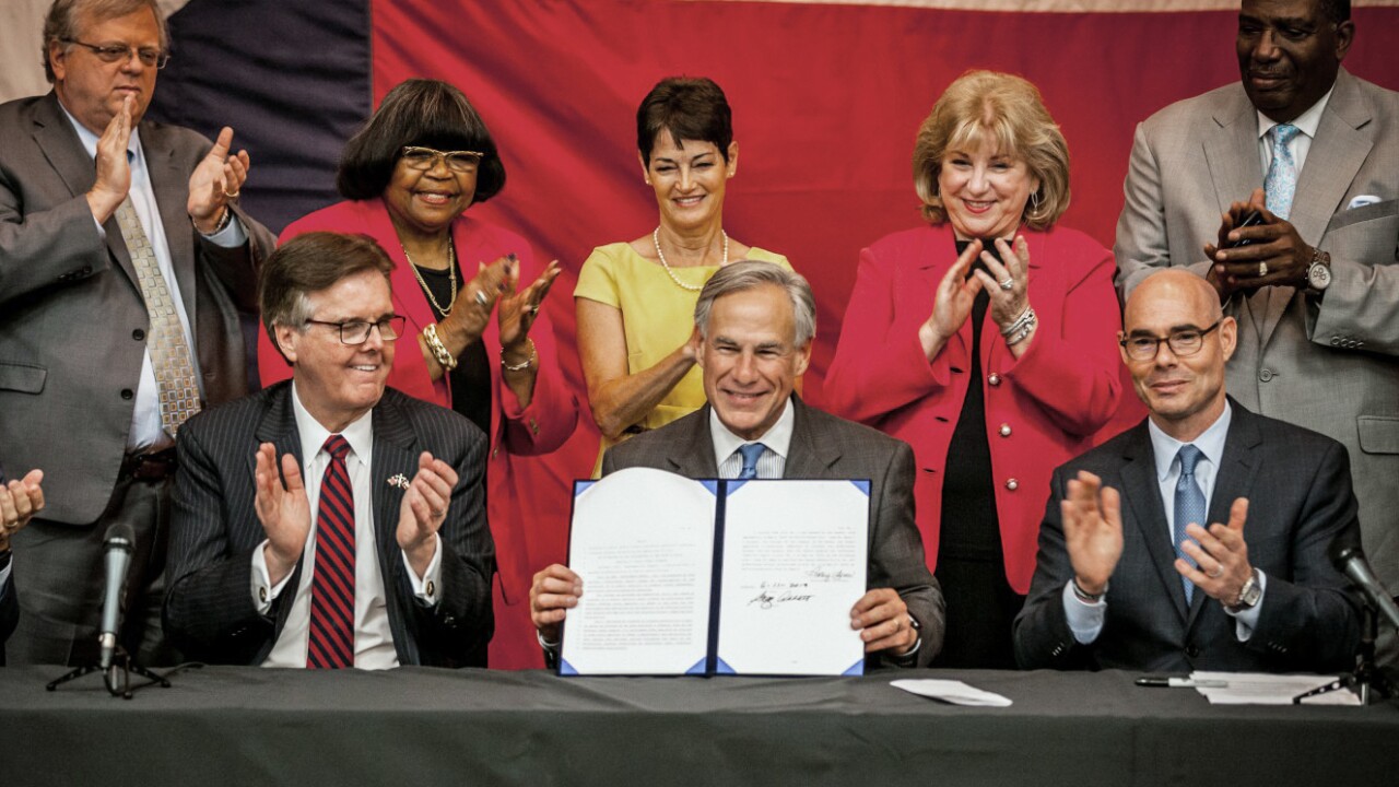 Texas Gov. Greg Abbott, center, at House Bill 3 signing June 11, 2019, with Lt. Gov. Dan Patrick, left, and House Speaker Dennis Bonnen.