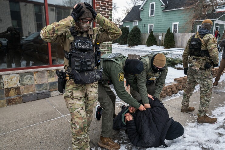 Federal agents detain a man in Minneapolis