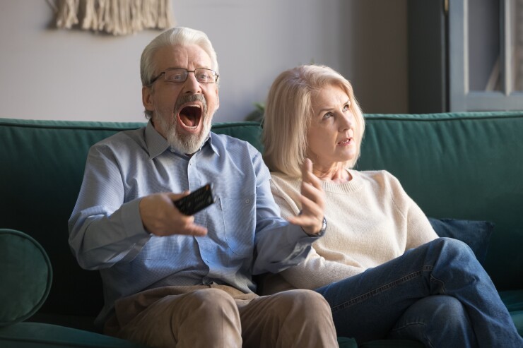 Senior mature couple with differing emotions anxiety anger distress