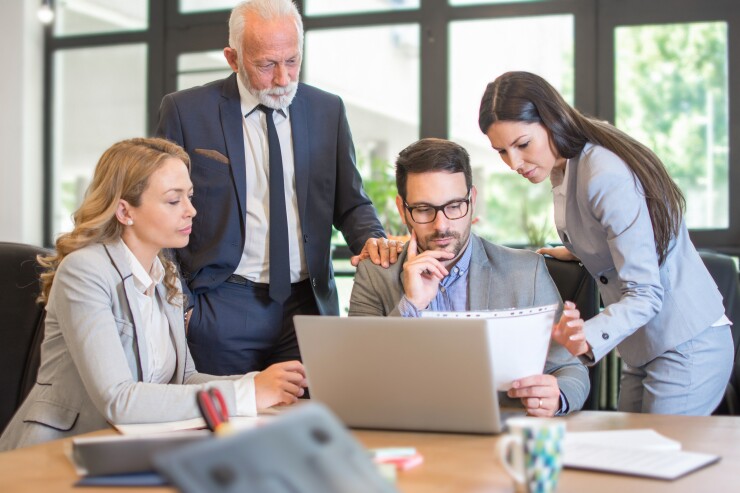 Group of mixed age business people discussing business strategy