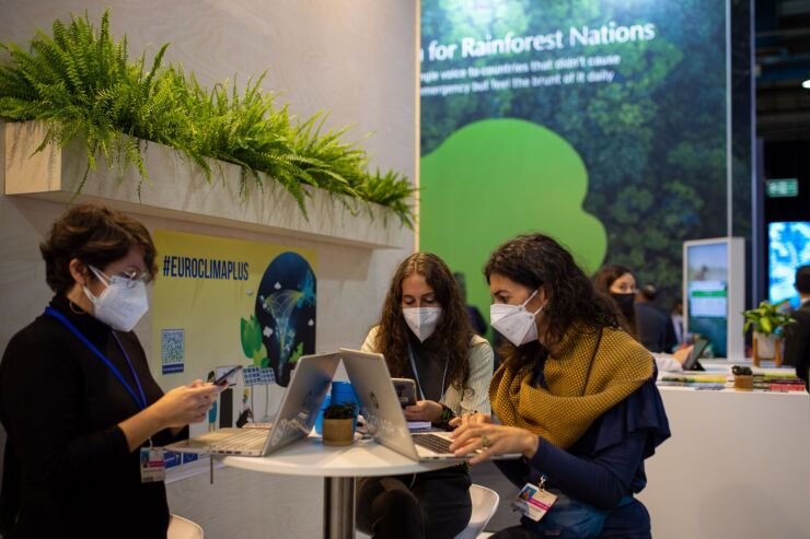 Attendees work from laptops during the COP26 climate talks in Glasgow, U.K., on Wednesday, Nov. 3, 2021. Climate negotiators at the COP26 summit were banking on the world’s most powerful leaders to give them a boost before they embark on two weeks of fraught discussions over who should do what to slow the rise in global temperatures. Photographer: Emily Macinnes/Bloomberg