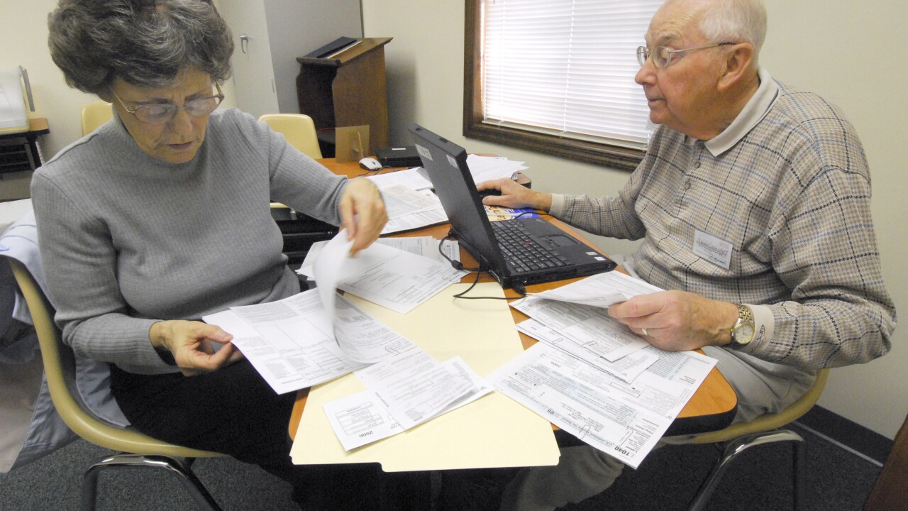A woman receives help from a volunteer preparer through the IRS VITA Program