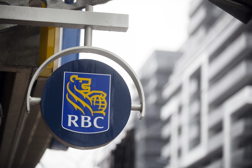 Small signage is displayed outside of a Royal Bank of Canada (RBC) branch during the company's annual general meeting in Toronto, Ontario, Canada, on Thursday, April 6, 2017