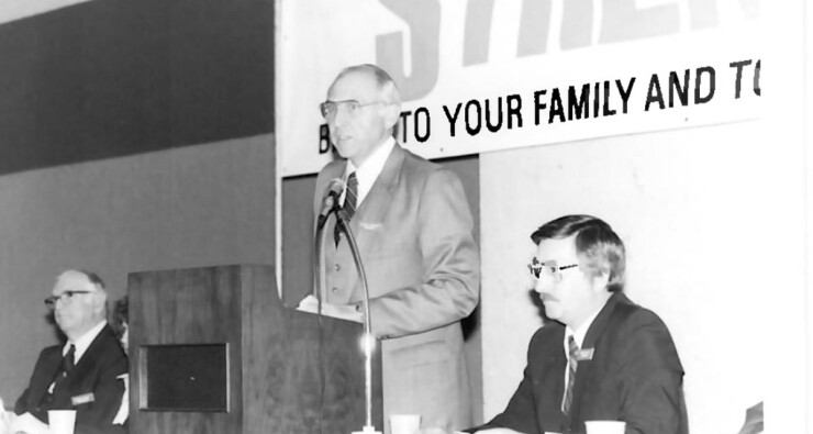 Calvin Phillips, center, speaking during a Dallas Postal CU annual meeting