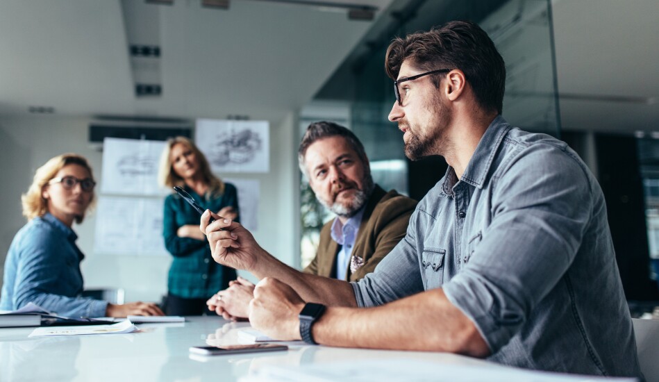 Male employee speaking to group in conference room